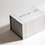 René Moritz, Artist's box 2014, Pappe, Acrylglas, Folie, Architektenpapier, Acrylglaslinse, Kerze, 10 x 7 x 6 cm, Auflage 50